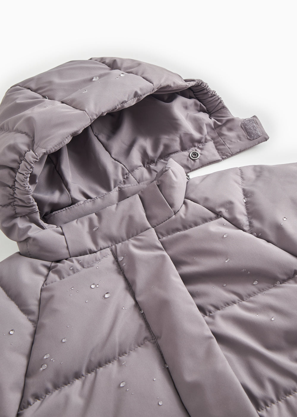 Pink down jacket with zipper and visible inner lining, plus a push button.
