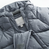 Dark gray jumpsuit with front zipper, sewn-in label, and small water droplets on the padding.