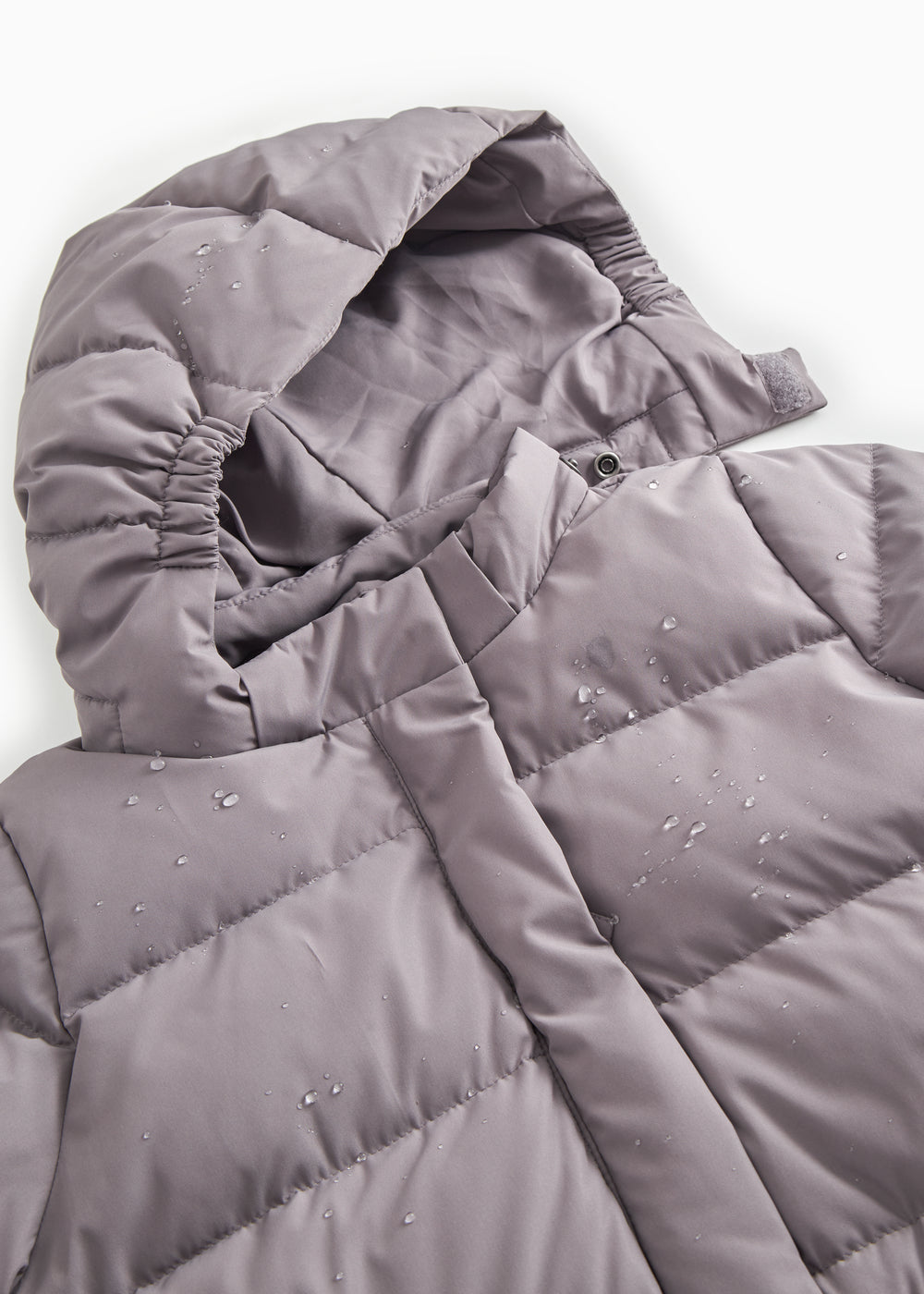 Down jacket collar and hood insert with visible stitching and snap buttons