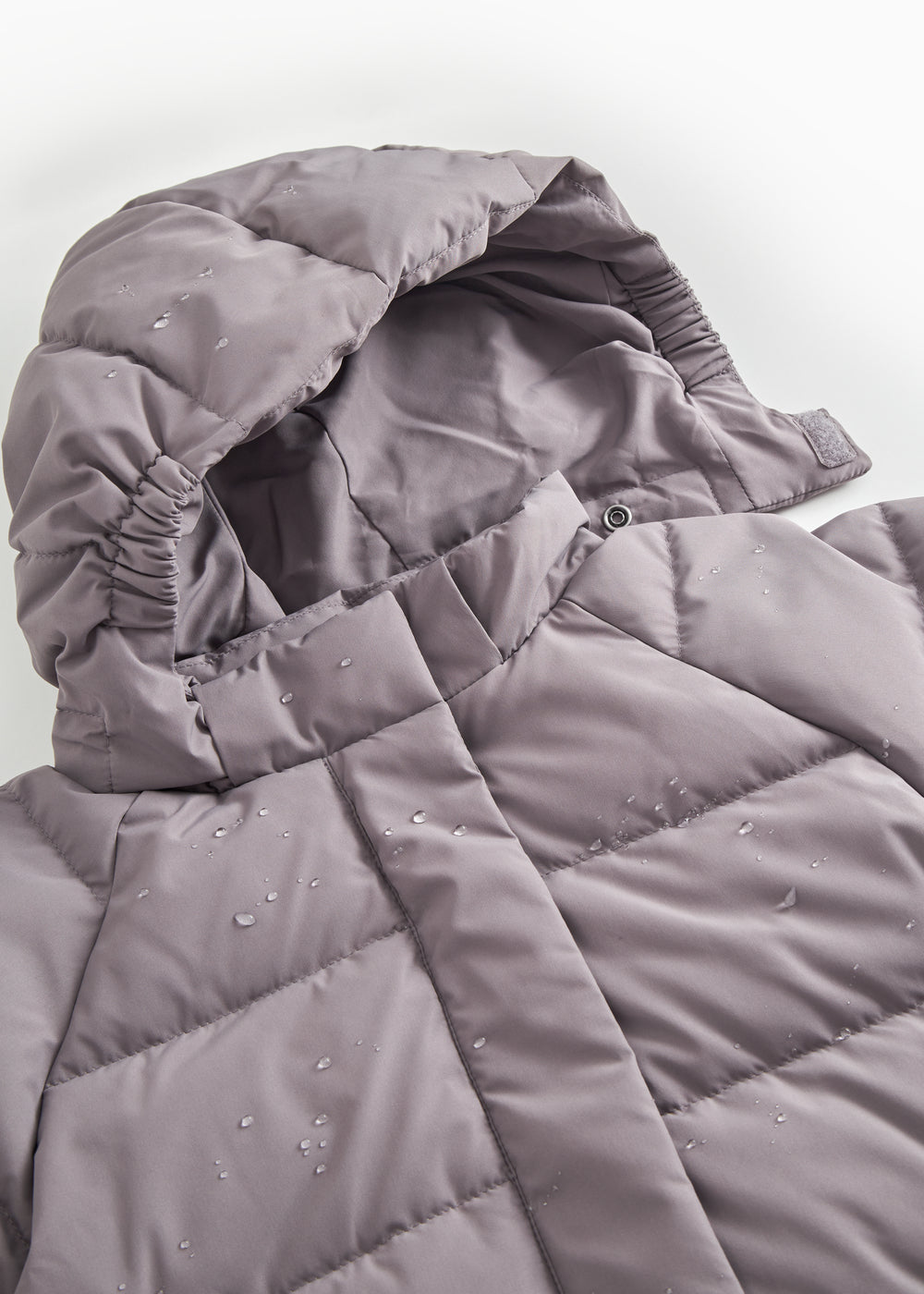 Purple padded down jacket with hood lining and a snap button at the collar.