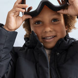 Children's down jacket in model with hood and padded lining.