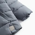 Gray down jacket for children with quilting, zipper, and a label patch at the bottom.