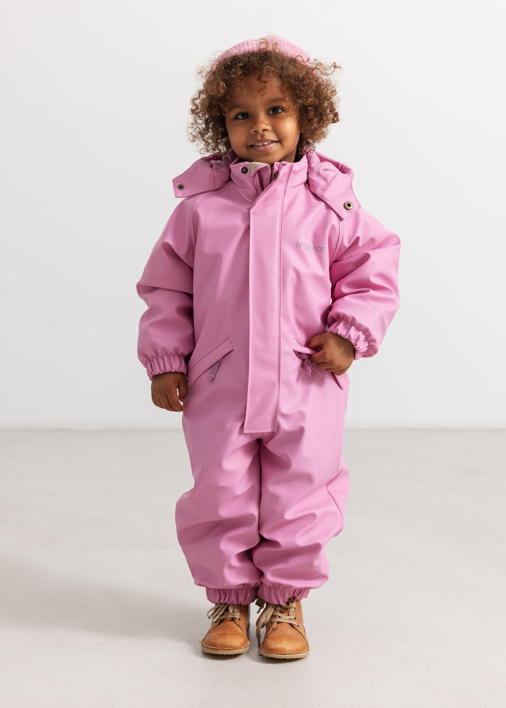 Pink PU flight suit with hood, zipper, and elastic cuffs.