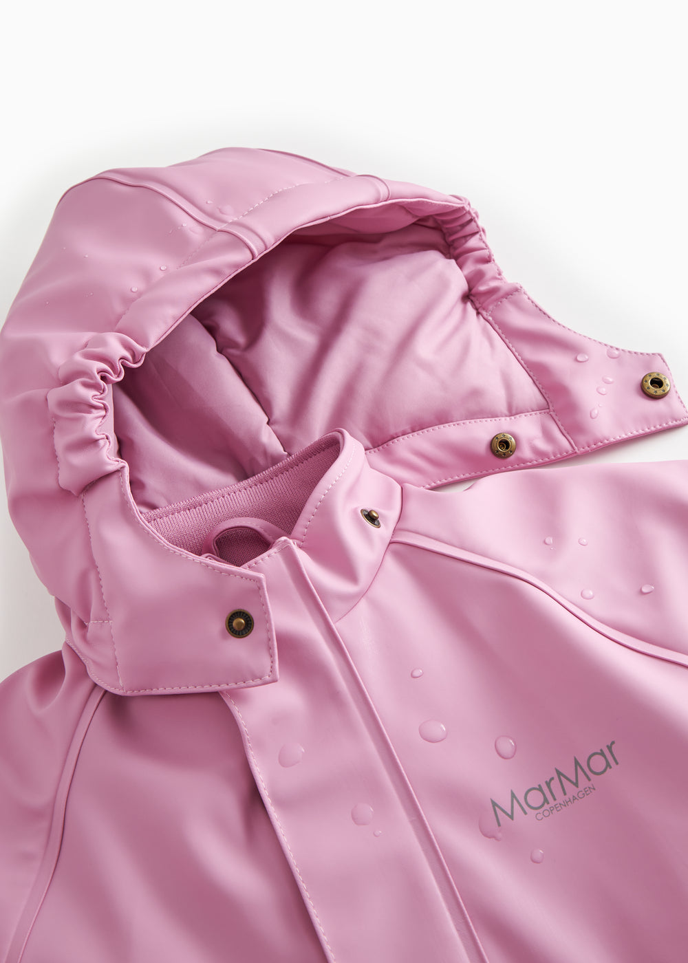 Pink PU flight suit with snap-closed front and hood, adjustable edge.