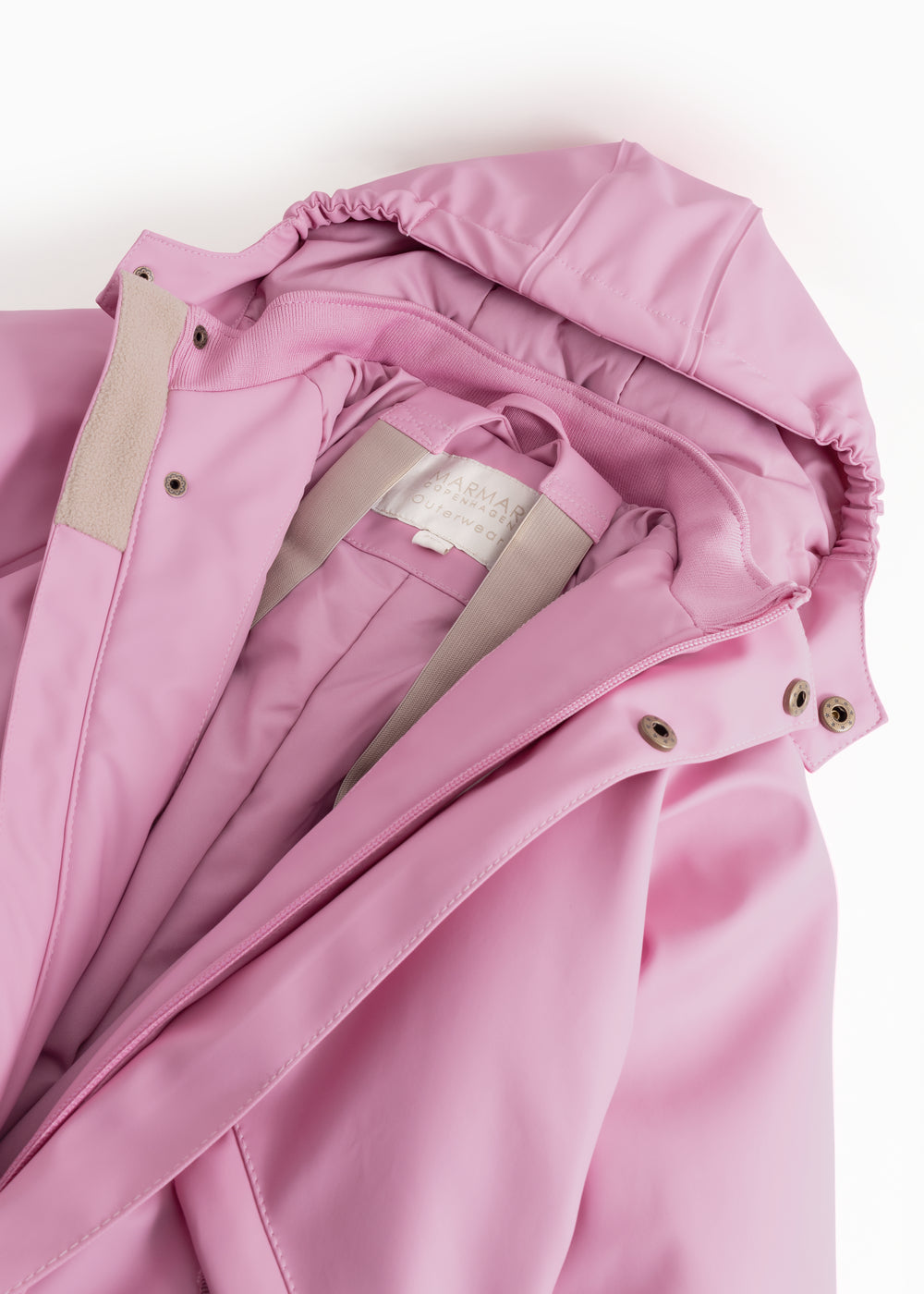 Pink PU jumpsuit with hood, zipper, and beige lining.