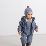 Light blue striped hat with red pom-pom and wide ribbed edge