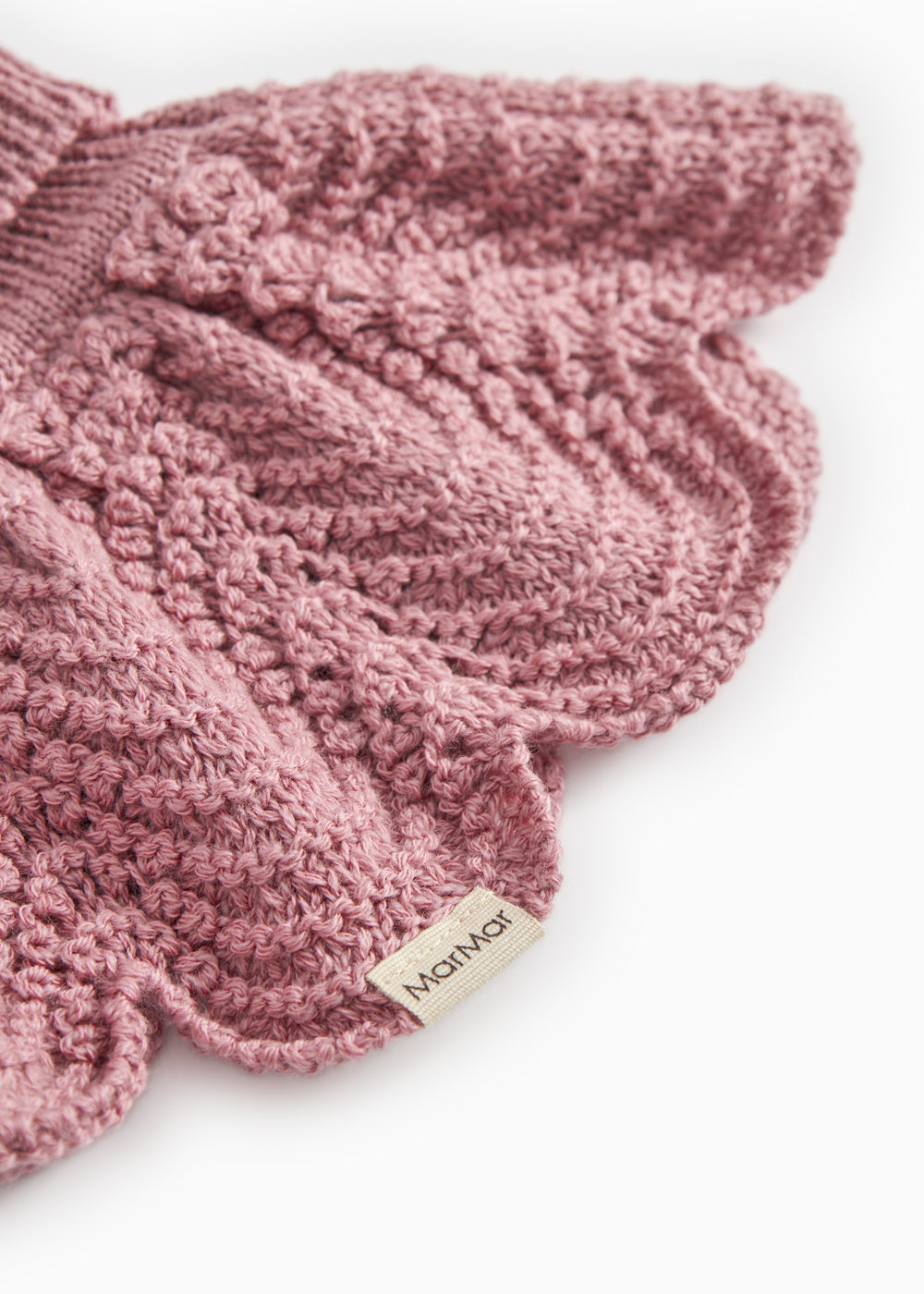 Knitted scarf in muted rose color with detailed pattern and Mølner brand.