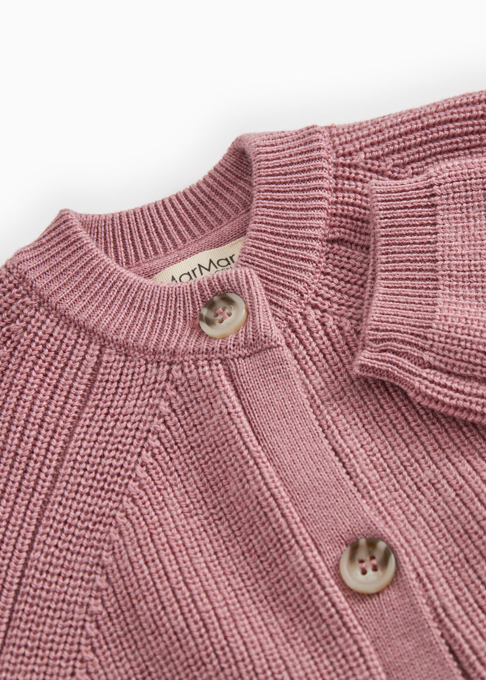 Sweater with round neck, button closure and fine textured pattern.