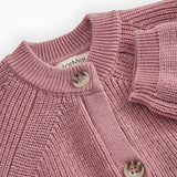Sweater with round neck, button closure and fine textured pattern.