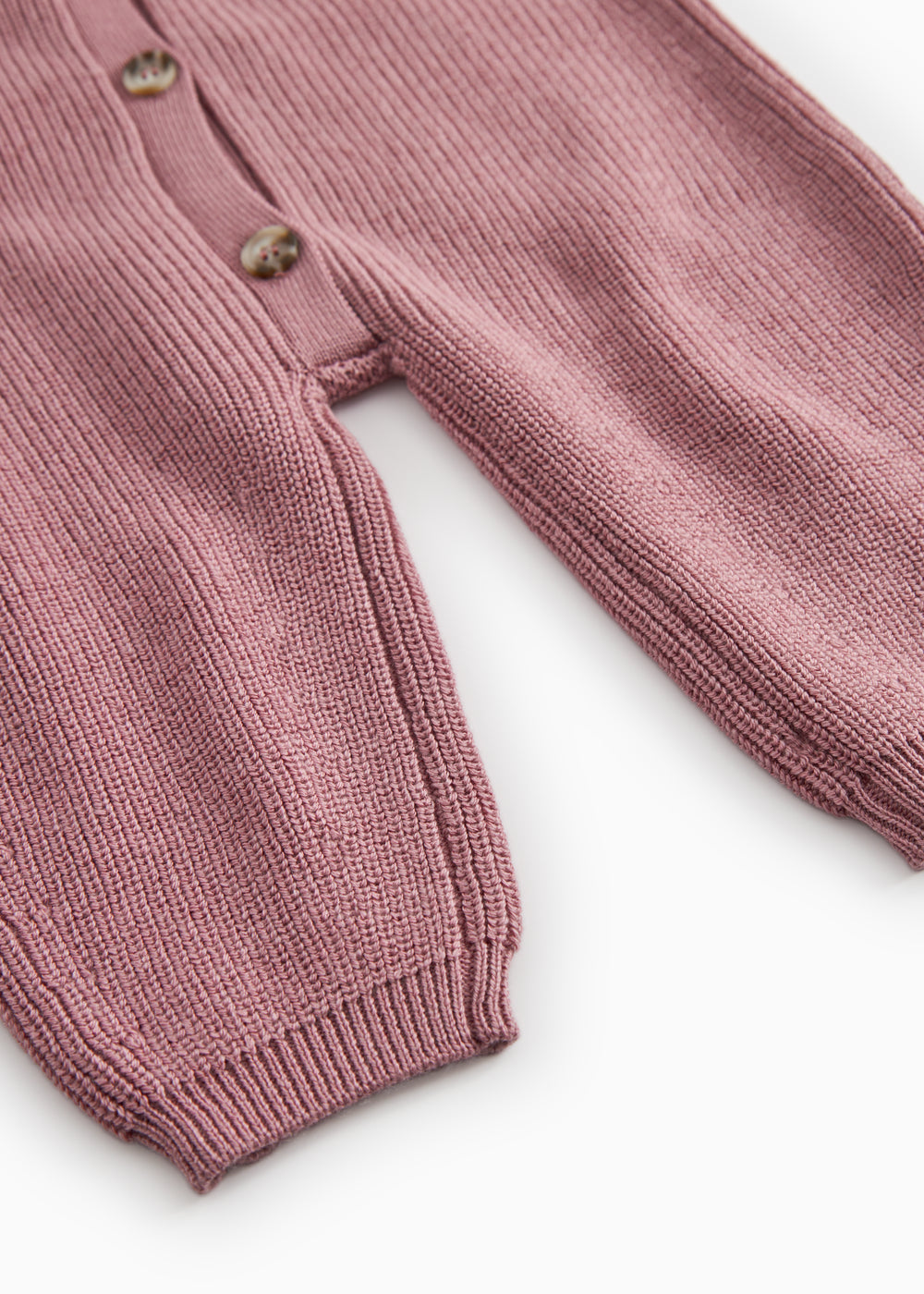 Dusty pink sweater dress with ribbed cuffs and button detail at the hem