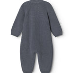 Dark blue knit suit with round neck and long legs, seen from behind.