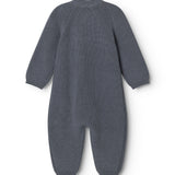 Dark blue knit suit with round neck and long legs, seen from behind.