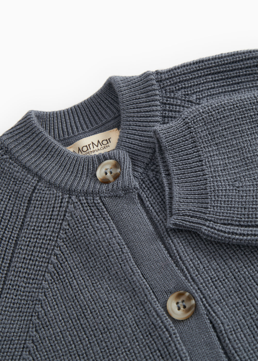Dark blue knit suit with rib collar, button closure, and marble brand.