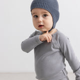 Gray striped hat with pompom, ribbed edge and ear pocket