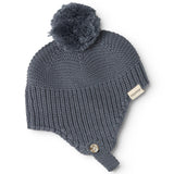 Gray knit cap in knit with pompom, label, and button detail.