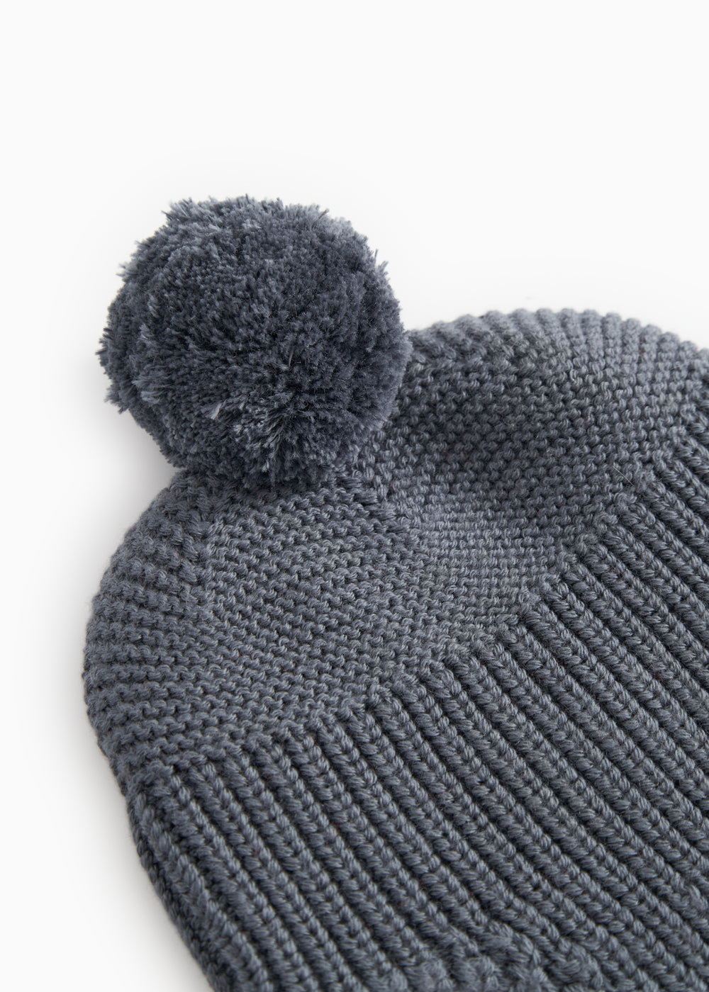 Gray knit hat with pompom and ribbed knit edges