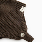 Dark brown ribbed hat with ribbing, snap closure, and label.