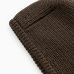 Dark brown ribbed knit hat with visible knit texture.