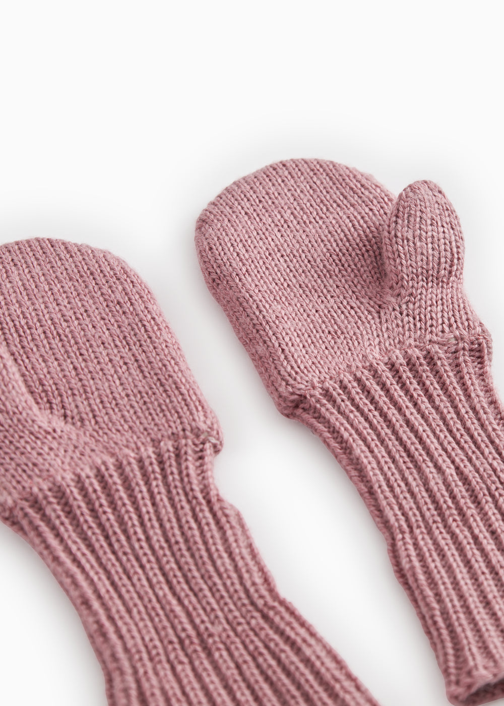 Knitted baby mittens in dusty rose with ribbed edge and thumb hole.