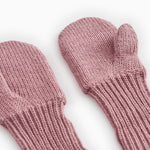 Knitted baby mittens in dusty rose with ribbed edge and thumb hole.