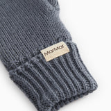 Dark gray woolen knit mittens with ribbing and logo label on the cuff.