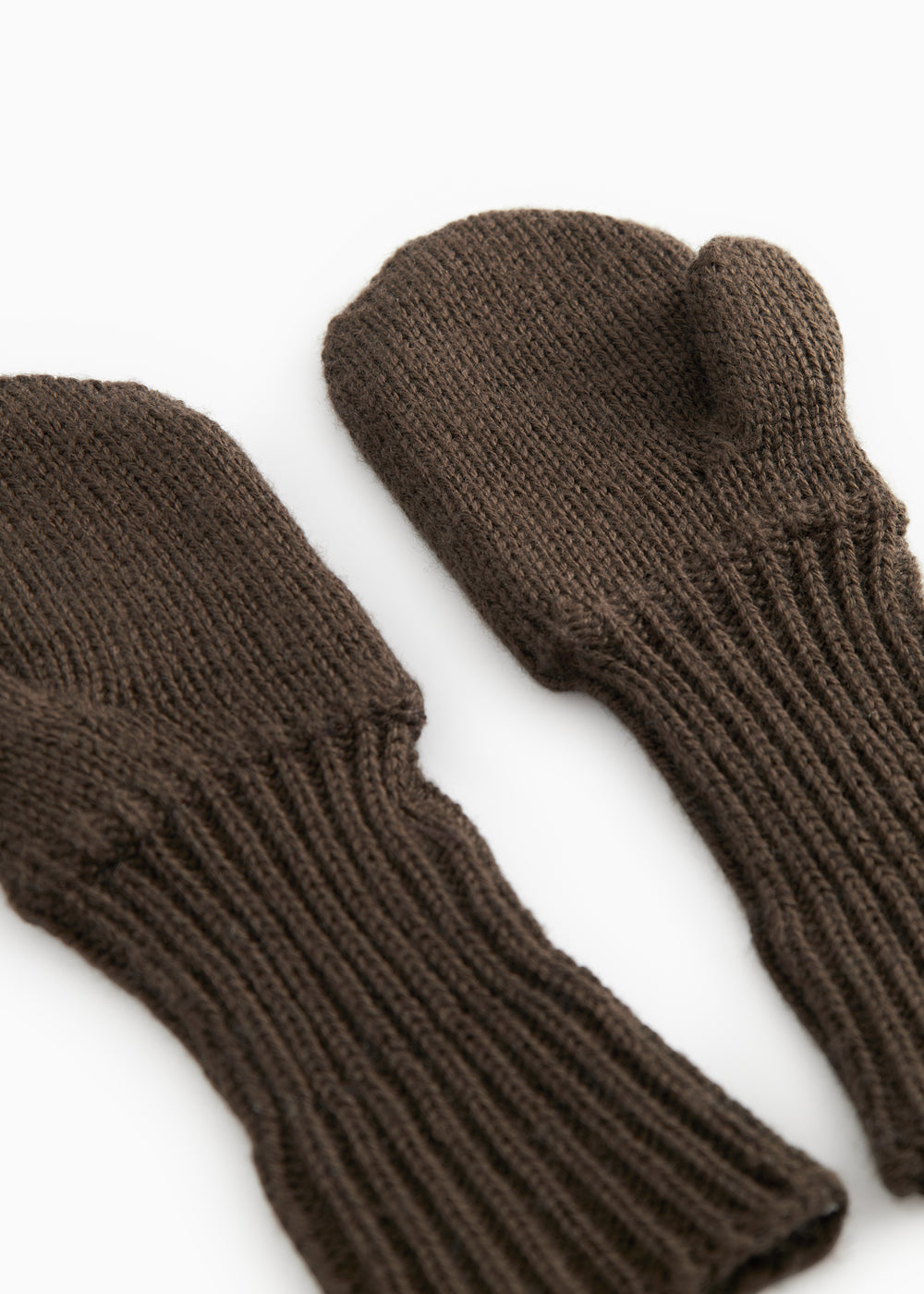 Dark brown knitted gloves with ribbed edge and thumb hole.