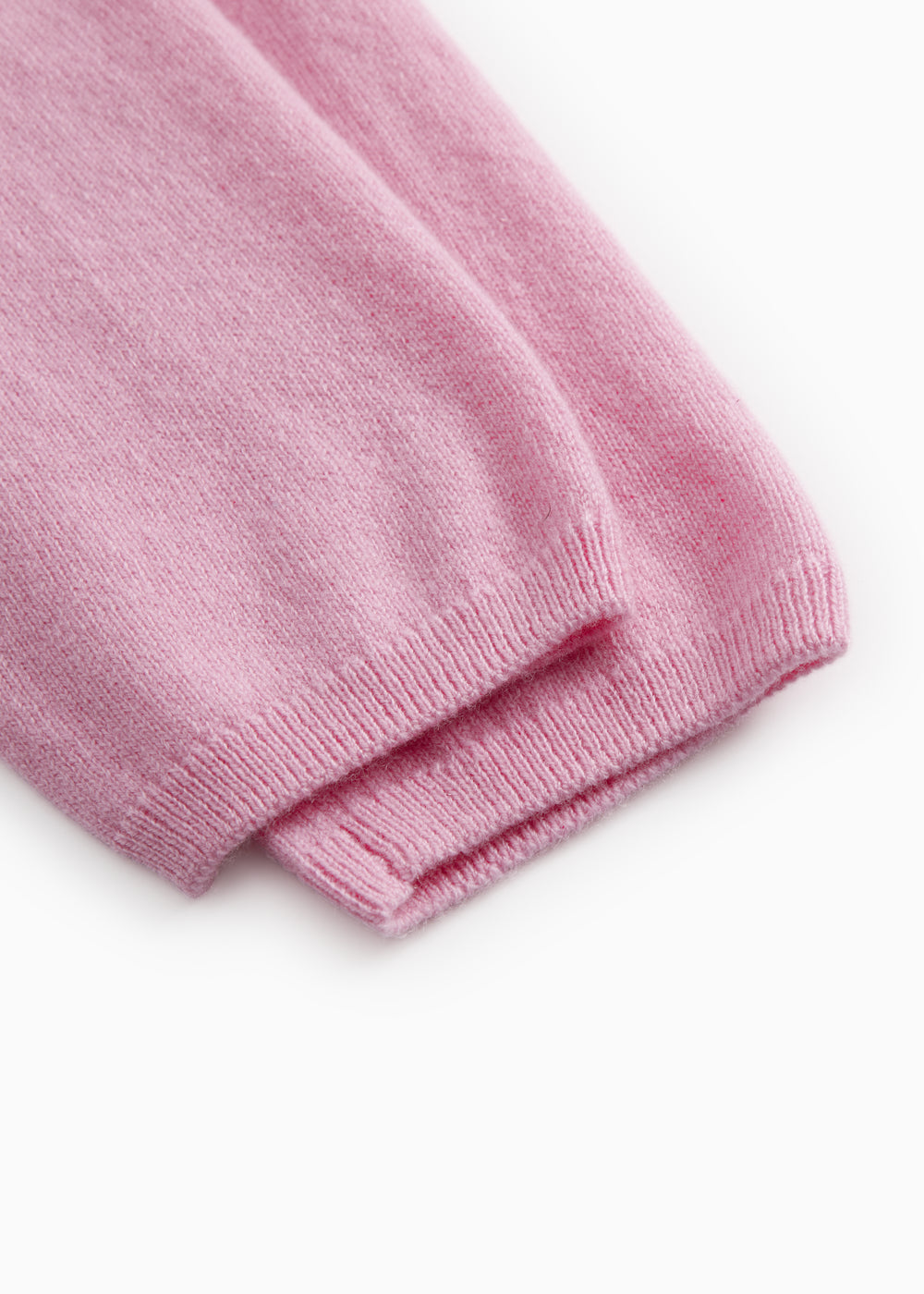 Pink Kashmir pants with ribbed hem at the leg ends.