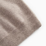 Gray textured knit sweater with ribbed cuffs.