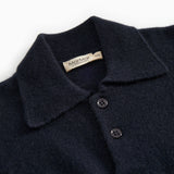 Button and collar on dark indigo polo shirt with two buttons