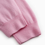 Pink Kashmir pants ending with a ribbed hem.