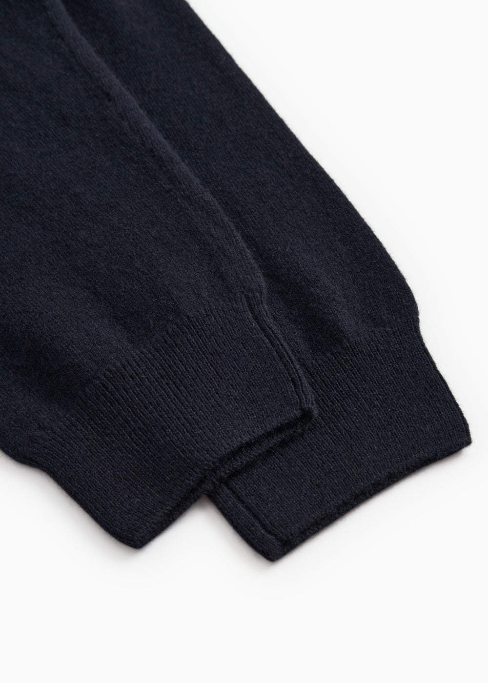 Indigo Kashmir trousers with elastic cuff and visible seam at the ankle.