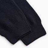Indigo Kashmir trousers with elastic cuff and visible seam at the ankle.
