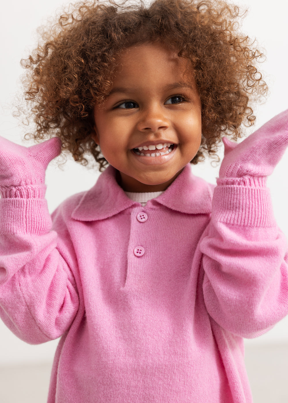 Pink striped baby onesie for small hands with ribbed cuffs at the wrist.