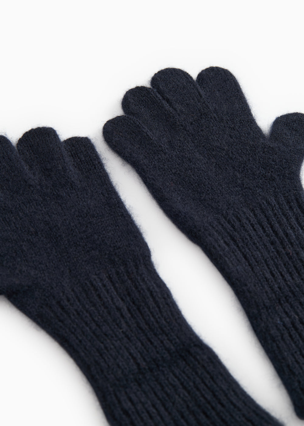 Long Kashmir handkerchief in dark indigo, close-up view of palms and ribbed cuff.