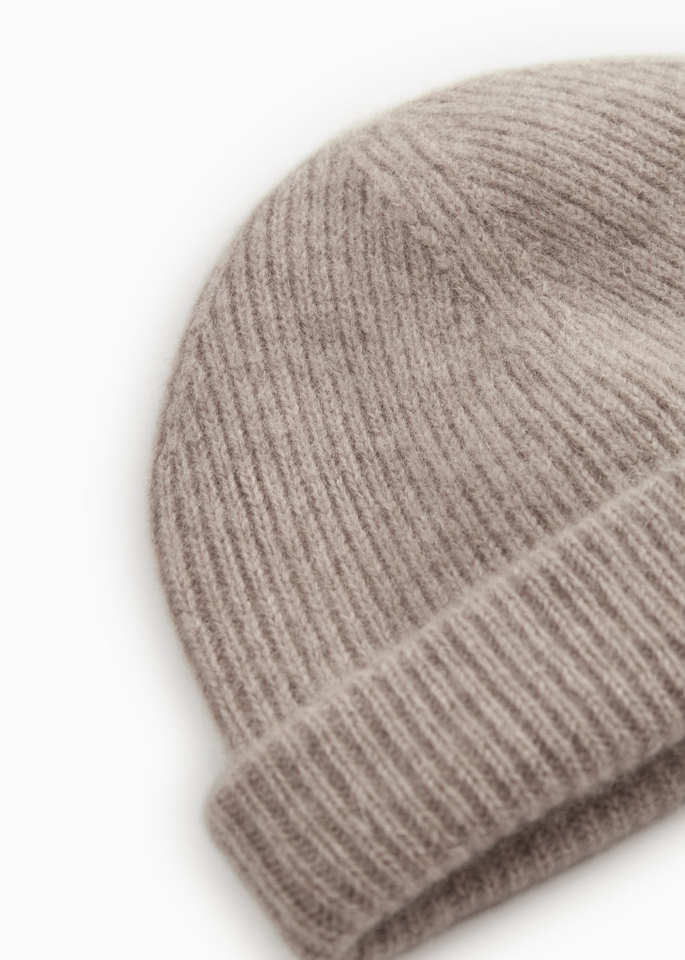 Close-up of sand-colored ribbed knit on an alpaca hat.