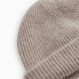 Close-up of sand-colored ribbed knit on an alpaca hat.