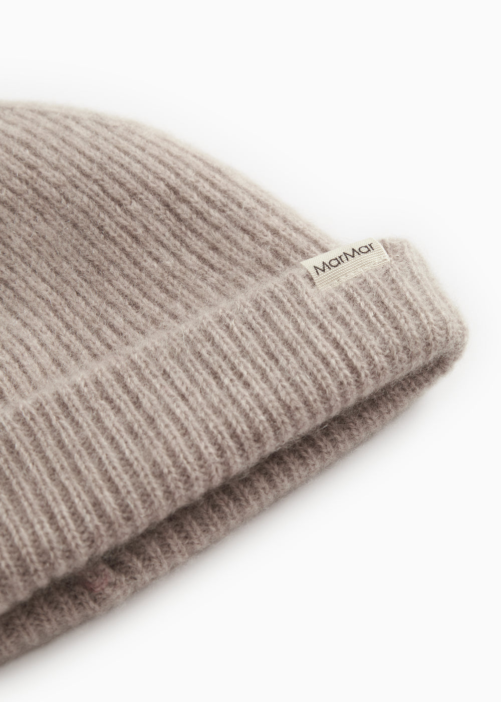 Label on sand-colored ribbed alpaca hat