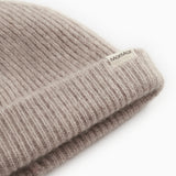 Label on sand-colored ribbed alpaca hat