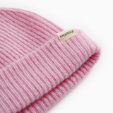 Details of pink Kashmir striped sweater hat with knit pattern and brand label.