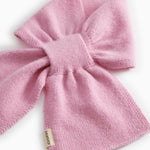 Pink knit scarf with bow knot and visible woven texture