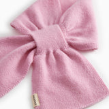 Pink knit scarf with bow knot and visible woven texture
