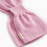 Pink knit baby blanket with label on the fold and rib edge.
