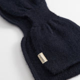 Dark indigo Kashmir scarf with stitching and logo tag at the end.