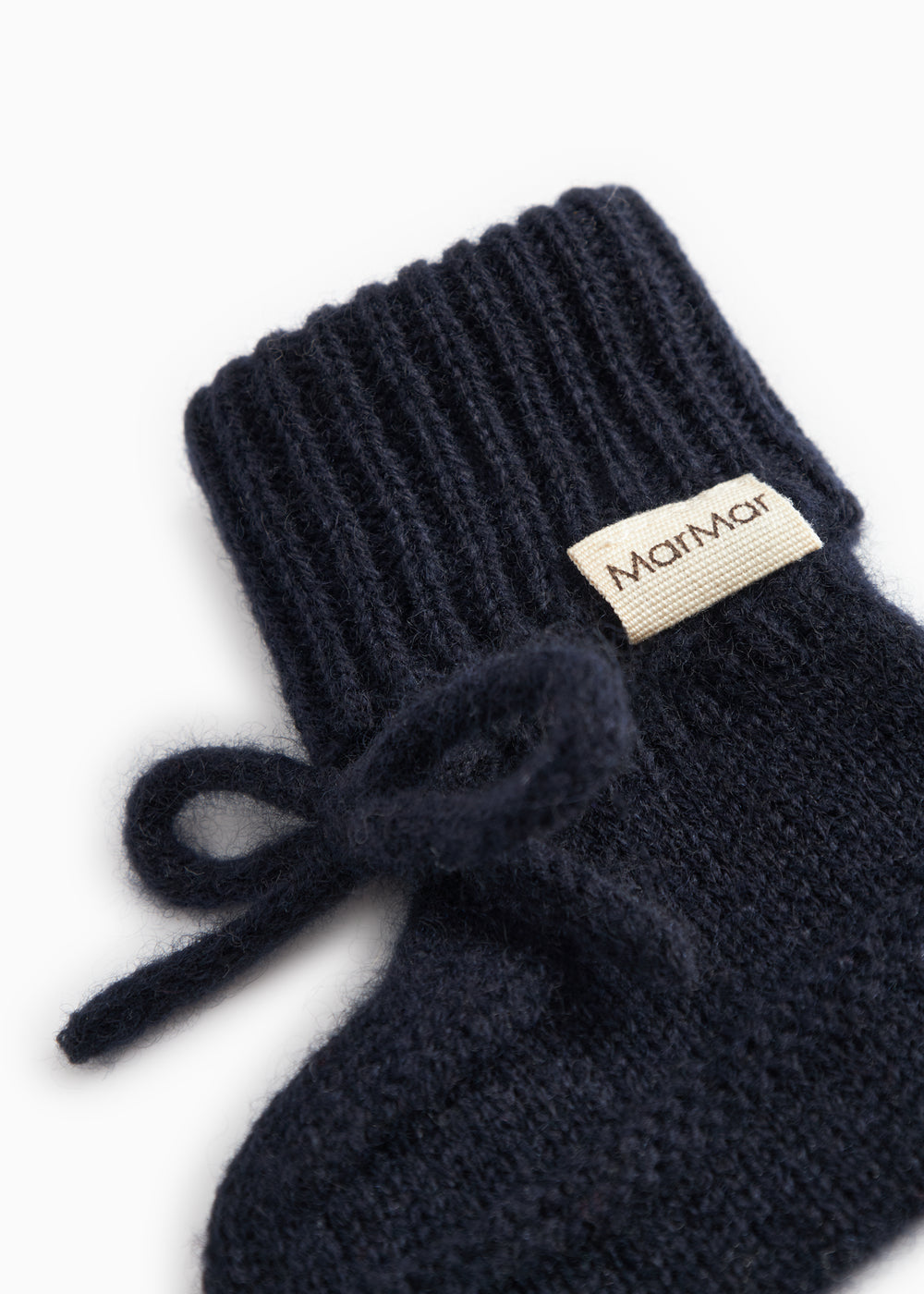Indigo knitted baby shoes with MarMar branding and a ribbon strap.