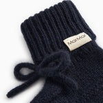 Indigo knitted baby shoes with MarMar branding and a ribbon strap.