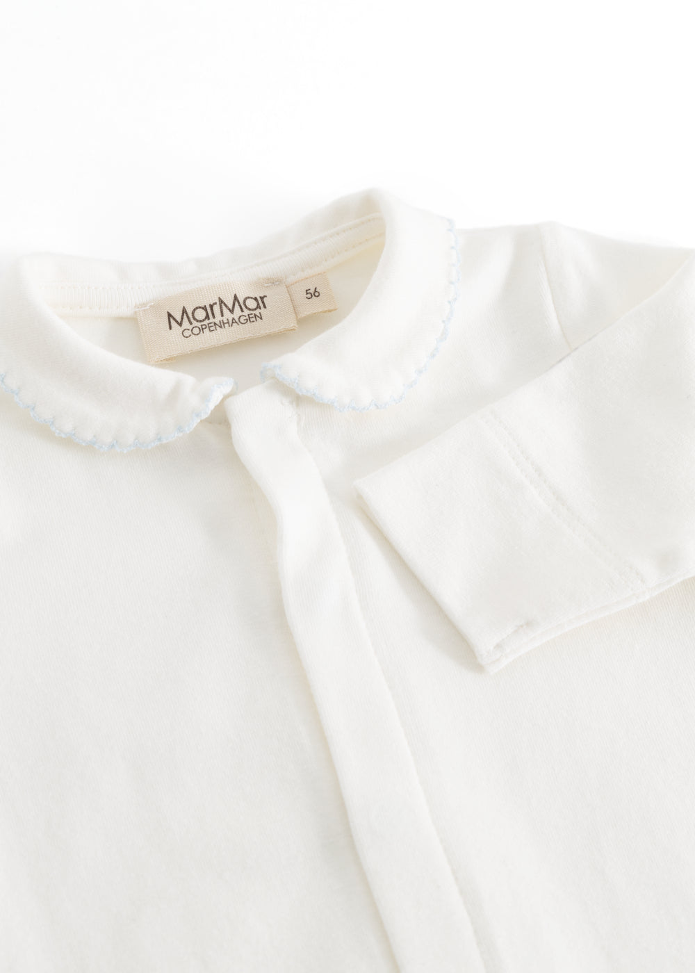 Ricci blouse in light off-white with a picot edge collar and button detail at the neck.