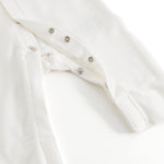 Ricci dress in light off-white with snap button closure and lace trim at the front.
