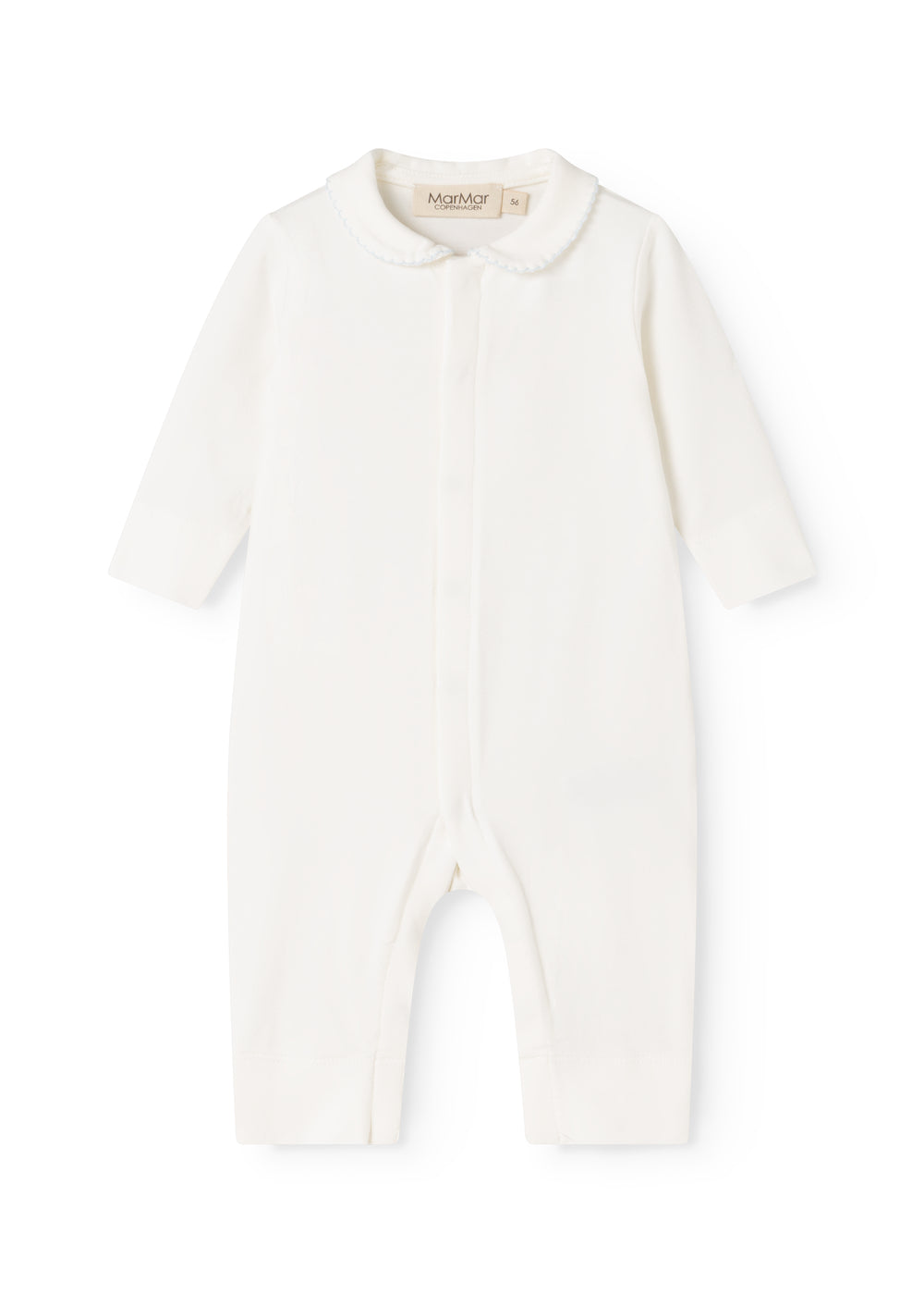 Ricci held a light off-white dress with long sleeves and a front button closure.