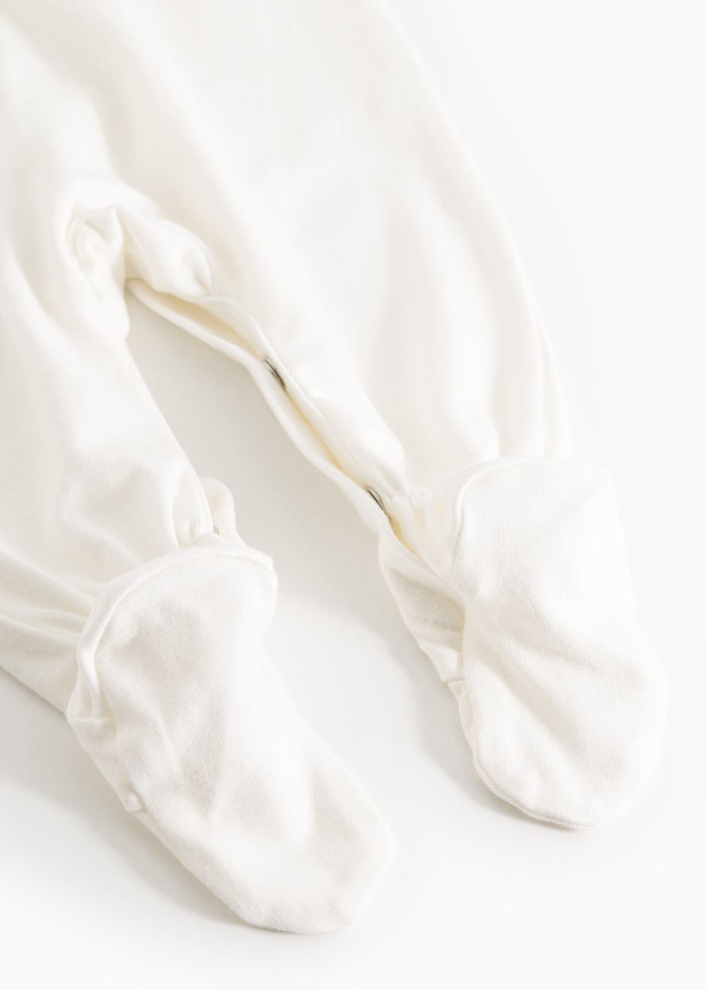 Sheath dress in light cream with ruffled cuffs at the feet