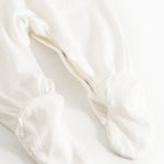 Sheath dress in light cream with ruffled cuffs at the feet